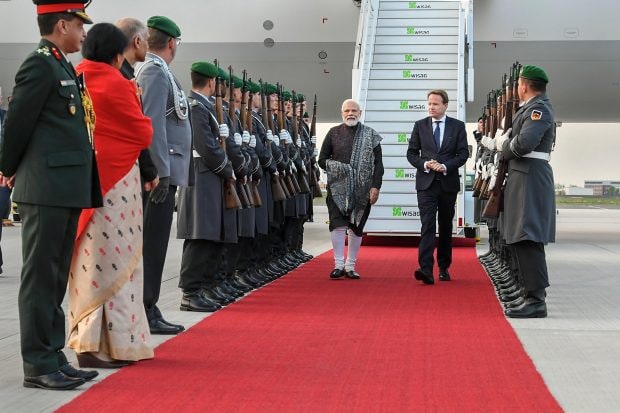 Prime Minister Narendra Modi being welcomed on his arrival in Berlin. PM Modi is on a three-day visit to Europe. (PTI Photo)