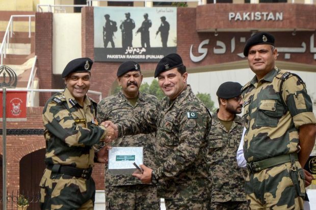 The Border Security Force and the Pakistan Rangers on Tuesday exchanged sweets at various outposts along the International Border in Jammu region on the occasion of Eid. The BSF offered the sweets to the Rangers and the latter also reciprocated the BSF's gesture by offering sweets. The BSF guards the around 2,290 km India-Pakistan International Border (IB) that runs north to south from Jammu, Punjab, Rajasthan and up to Gujarat on India's western flank. (PTI Photo)