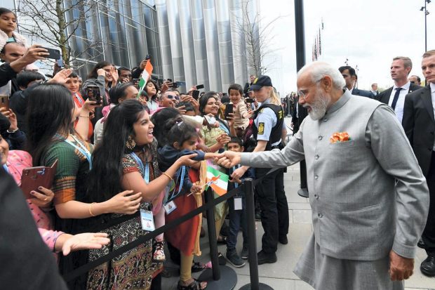 Prime Minister Narendra Modi greets the members of the Indian community during his visit to Copenhagen, in Denmark. (PTI Photo)