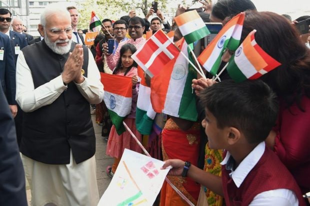 Prime Minister Narendra Modi greets the members of the Indian community during his visit to Copenhagen, in Denmark. (PTI Photo)