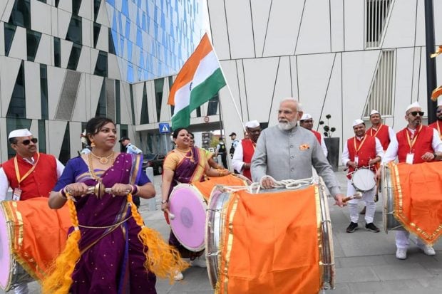 Prime Minister Narendra Modi plays 'dhol' before meeting the members of the Indian community, in Copenhagen, Denmark. (PTI Photo)