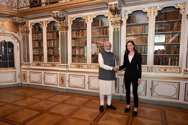 Prime Minister Narenda Modi shakes hands with Finnish Prime Minister Sanna Marin ahead of his meeting with five nordic countries, at Christiansborg Castle, in Copenhagen, Denmark. (AP Photo)