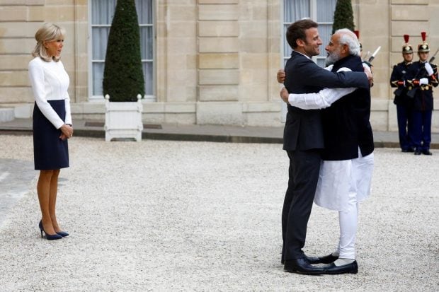 France's President Emmanuel Macron, accompanied by his wife Brigitte Macron, welcomes Prime Minister Narendra Modi before a meeting at the Elysee Palace in Paris, France. (Reuters Photo)