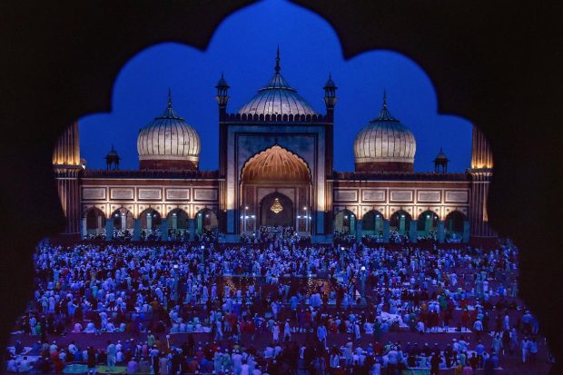 Muslims arrive to offer prayers at the Jama Masjid on the occasion of Eid-ul-Fitr, in old Delhi. (PTI Photo)