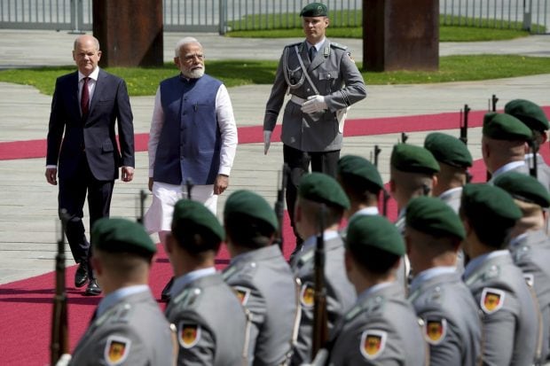 German Chancellor Olaf Scholz welcomes Prime Minister Narendra Modi with military honors for a meeting at the chancellery in Berlin, German. (AP Photo)