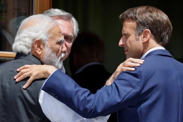 Argentina's President Alberto Fernandez looks on as Prime Minister Narendra Modi and France's President Emmanuel Macron greet each other as they arrive to attend the outreach program during the G7 leaders' summit at the Bavarian resort of Schloss Elmau castle, near Garmisch-Partenkirchen, Germany. (Reuters Photo)