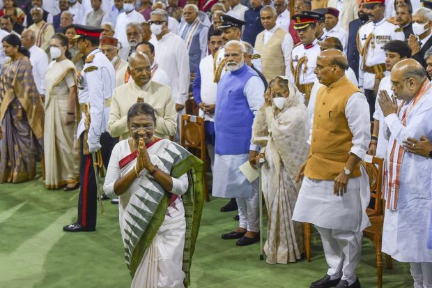 President Droupadi Murmu exchanges greetings with dignitaries during her oath ceremony in the Central Hall of Parliament, in New Delhi. (PTI Photo)