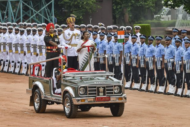 President Droupadi Murmu receives the Tri-services guard of honour in the forecourt of the Rashtrapati Bhavan, in New Delhi. (PTI Photo)