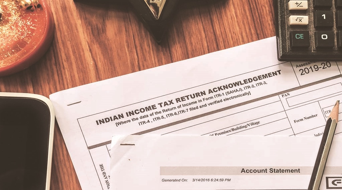 Close up of Indian Income tax return form ITR-2 return form is on the table next to a pen, calculator and a home mortgage loan application form placed on the desk.