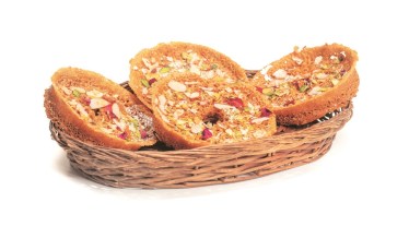 Ghewar is a very popular Rajasthani sweet made with ghee, flour, and sugar syrup.