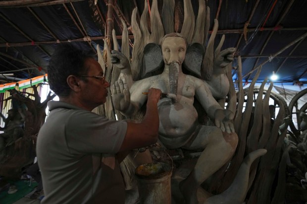 An artisan prepares eco-friendly idols of elephant-headed Hindu god Ganesha ahead of Ganesh Chaturthi festival in Hyderabad, India, Wednesday, Aug. 17, 2022. (AP Photo)
