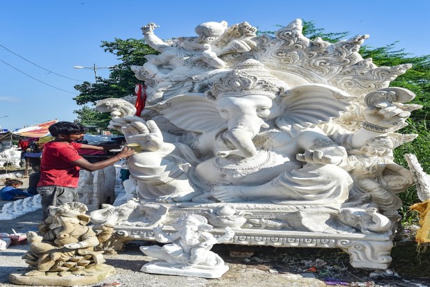 New Delhi: An artist gives final touches to an idol of Lord Ganesha ahead of the upcoming 'Ganesh Chaturthi' festival, in New Delhi, Wednesday, Aug. 17, 2022. (PTI Photo)