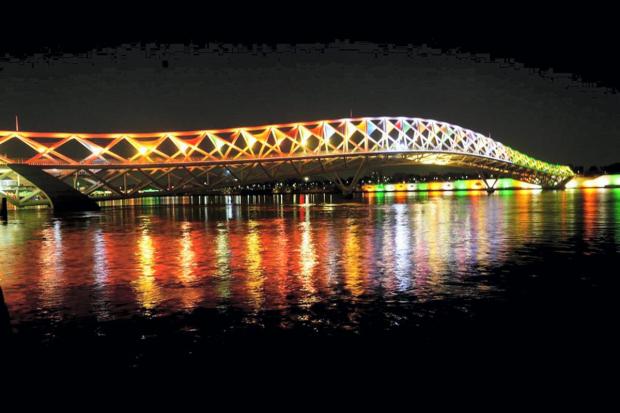 Atal Bridge over Sabarmati river illuminated with lights during its inauguration, in Ahmedabad. (PTI Photo)