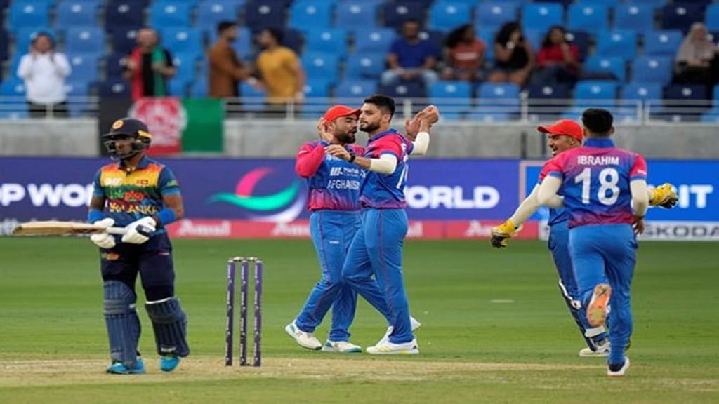 Afghanistan's Naveen-ul-Haq, center, celebrates with teammates after taking the wicket of Sri Lanka's Pathum Nissanka during the T20 cricket match of Asia Cup between Afghanistan and Sri Lanka, in Dubai, United Arab Emirates, Saturday, Aug. 27, 2022. (AP Photo/Anjum Naveed)
