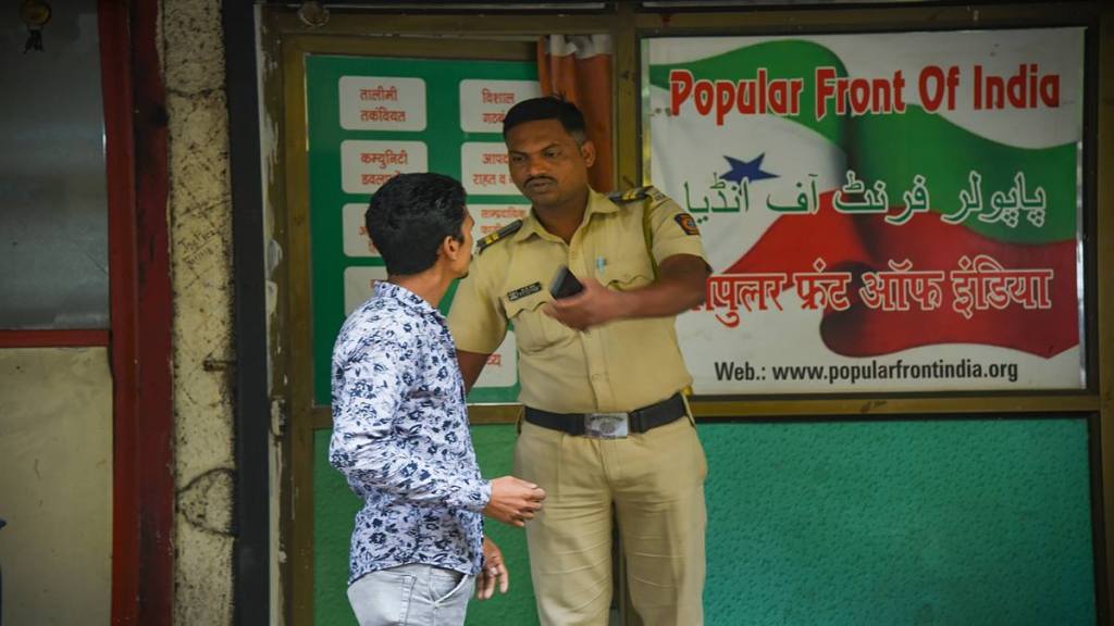 A security person keeps vigil outside the Popular Front of India (PFI) party office in Navi Mumbai on Thursday. (PTI Photo)