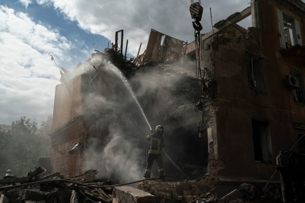 A firefighter works to extinguish a fire after a Russian attack that heavily damaged a residential building in Sloviansk, Ukraine, Wednesday, Sept. 7, 2022. (AP Photo)