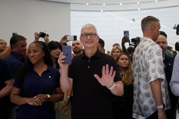 Apple CEO Tim Cook holds up an iPhone 14 Pro at an Apple event on the campus of Apple's headquarters in Cupertino, Calif., Wednesday, Sept. 7, 2022. (AP Photo)