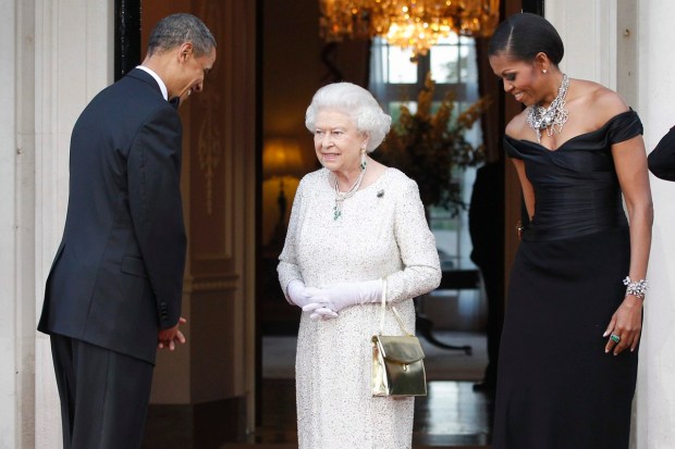 US President Barack Obama and first lady Michelle Obama welcome Queen Elizabeth II for a reciprocal dinner at Winfield House in London, May 25, 2011. (AP Photo)