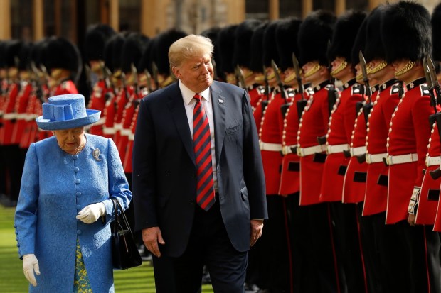 US President Donald Trump and Queen Elizabeth II inspect a Guard of Honour, formed of the Coldstream Guards at Windsor Castle in Windsor, England, July 13, 2018. (AP Photo)