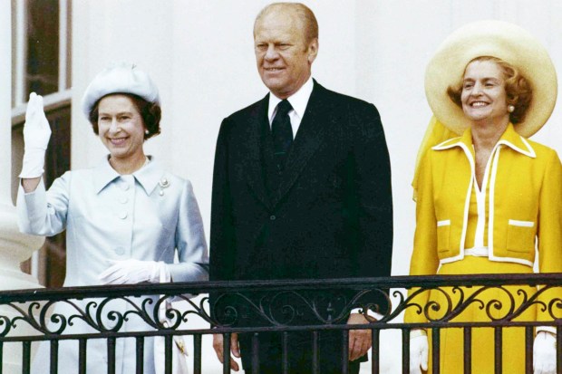 Queen Elizabeth II, left, waves from the balcony of the White House, in Washington as she stands with U.S. President Gerald Ford and first lady Betty Ford on July 7, 1976. (AP Photo)
