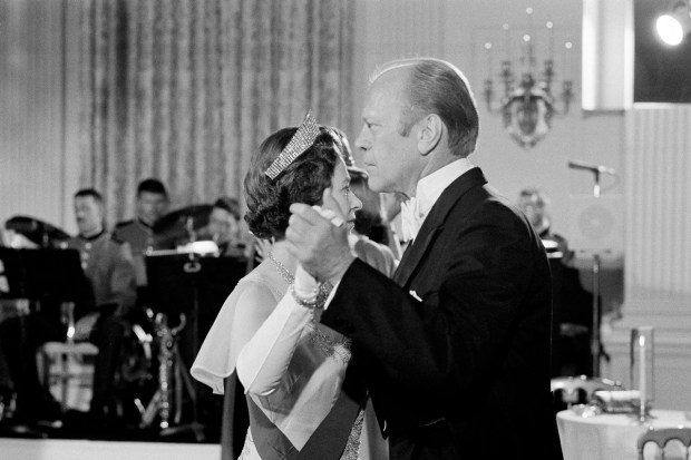 US President Gerald Ford dances with Britain's Queen Elizabeth II in the State Dining Room at the White House, following a State Dinner in the queen's honor on July 7, 1976. (AP Photo)