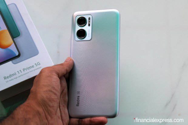 Redmi 11 Prime 5G has a textured back panel with a smooth matte finish. The sides are flat. It isn't the slimmest or lightest phone in its class but it's built well and feels solid in the hands. Staple Xiaomi features like IR blaster and side-mounted fingerprint reader are available. You get a headphone jack which is capable of pulling Hi-Res Audio. (Photo credit: Saurabh Singh/Financial Express)