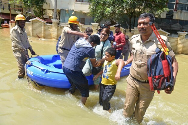 Firefighters help evacuate residents from a flooded area after heavy rainfall in Bangalore, India, Monday, Sept. 5, 2022. Life for many in the southern Indian city of Bengaluru was disrupted on Tuesday after two days of torrential rains set off long traffic snarls, widespread power cuts and heavy floods that swept into homes and submerged roads. (AP Photo)