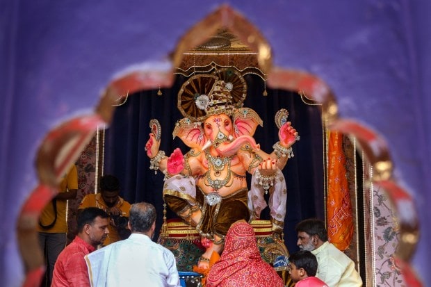 Devotees worship Lord Ganesh at a pandal on the occasion of Ganesh Chaturthi festival in Beawar. (PTI Photo)