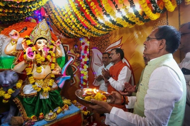 Madhya Pradesh Chief Minister Shivraj Singh Chouhan with BJP State President VD Sharma and others, offers prayers during the installation of an idol of Lord Ganesh at BJP state headquarters, on the occasion of Ganesh Chaturthi, in Bhopal. (PTI Photo)