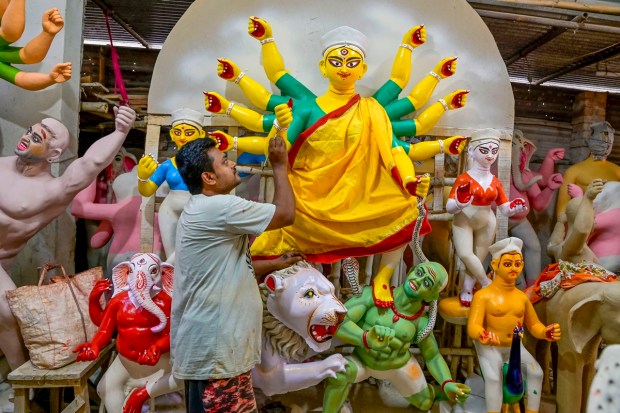 Nadia: An artisan paints a clay idol of Goddess Durga at a workshop, ahead of the celebrations of Durga Puja, in Nadia. (PTI Photo)