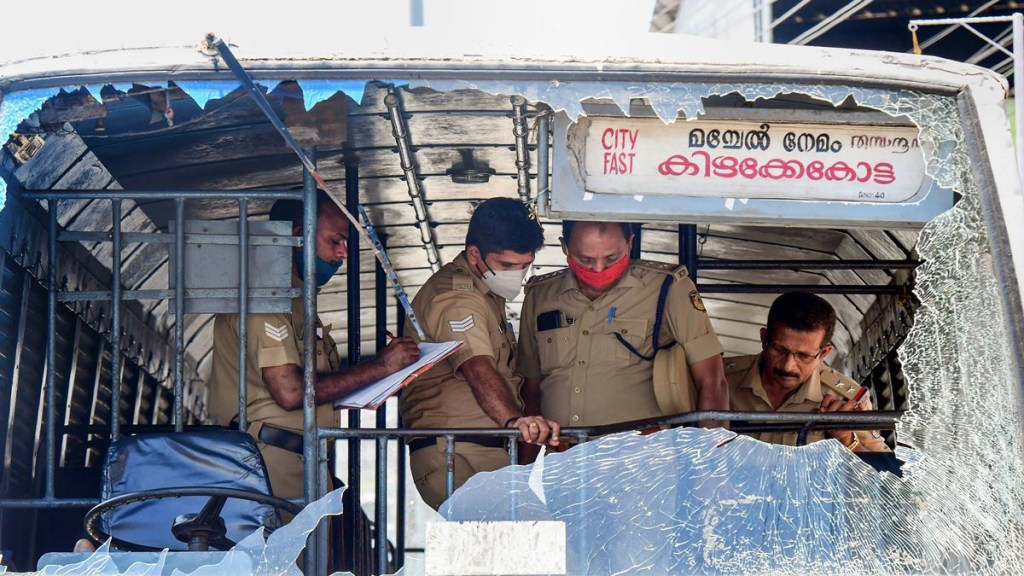 Police personnel take stock of the damages done to a KSRTC bus after some miscreants threw stones on it during PFI hartal in Kerala. (PTI Photo) Police personnel take stock of the damages done to a KSRTC bus after some miscreants threw stones on it during PFI hartal in Kerala. (PTI Photo)