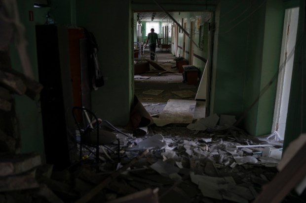 A man walks in a corridor of a psychiatric hospital that was heavily damaged after a Russian attack in Kramatorsk, Ukraine, Wednesday, Sept. 7, 2022. (AP Photo)