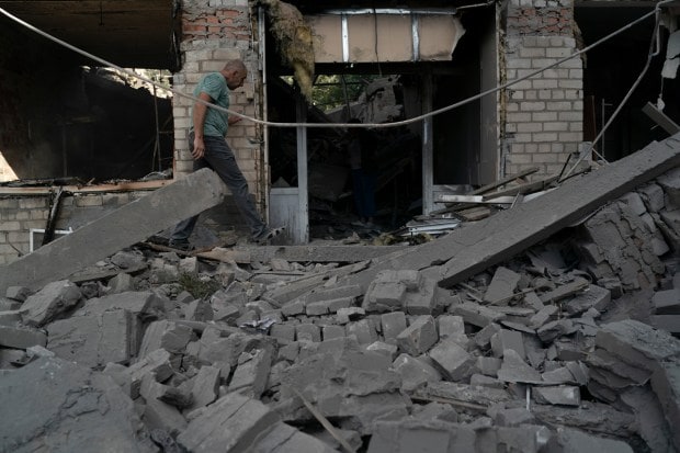 A man walks over debris of a psychiatric hospital that was heavily damaged after a Russian attack in Kramatorsk, Ukraine, Wednesday, Sept. 7, 2022. (AP Photo)