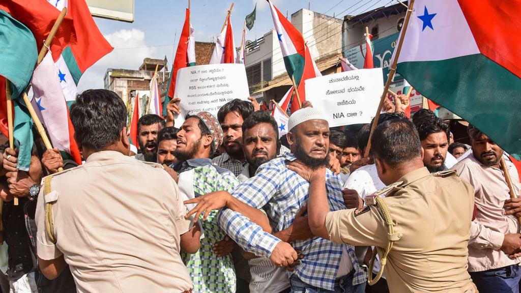 Police attempt to detain PFI and Social Democratic Party of India (SDPI) workers during a protest against NIA raids in Hubballi on Sep 22. (PTI Photo) Police attempt to detain PFI and Social Democratic Party of India (SDPI) workers during a protest against NIA raids in Hubballi on Sep 22. (PTI Photo)