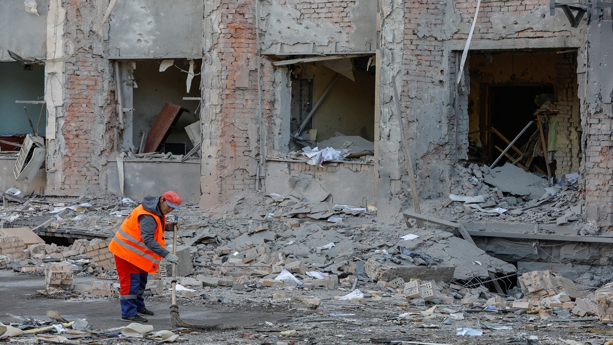 A worker cleans a road near the city administration building hit by recent shelling in the course of Ukraine-Russia conflict, in Donetsk, Russian-controlled Ukraine (Reuters image)