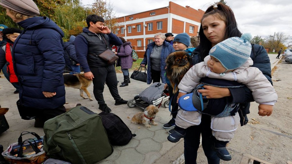 Civilians evacuated from the Russian-controlled city of Kherson wait to board a bus heading to Crimea (Reuters image) Civilians evacuated from the Russian-controlled city of Kherson wait to board a bus heading to Crimea (Reuters image)
