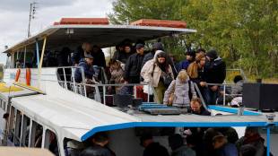 Civilians evacuated from the Russian-controlled city of Kherson arrive by ferry in the town of Oleshky (Reuters image)