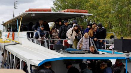 Civilians evacuated from the Russian-controlled city of Kherson arrive by ferry in the town of Oleshky (Reuters image)