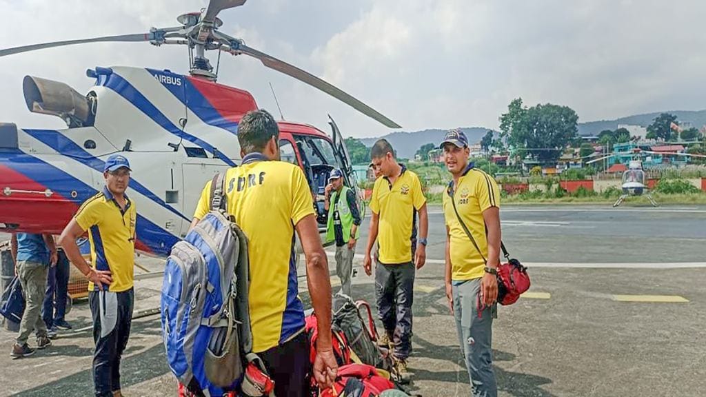 SDRF teams leave from Sahastradhara helipad to rescue the trainees trapped in an avalanche in Draupadi's Danda-2 mountain peak, in Dehradun district. (PTI Photo)