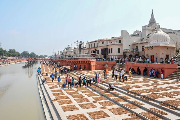 Locals arrange earthen lamps at Ram Ki Pauri in preparation for the 'Deepotsav' celebrations, in Ayodhya.