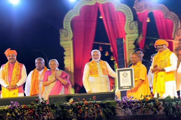 Uttar Pradesh Chief Minister Yogi Adityanath holds the certificate of Guinness World Record for largest display of oil lamps as Prime Minister Narendra Modi, Uttar Pradesh Governor Anandiben Patel and Deputy Chief Ministers Brajesh Pathak and Keshav Prasad Maurya look on, during Deepotsav celebrations.