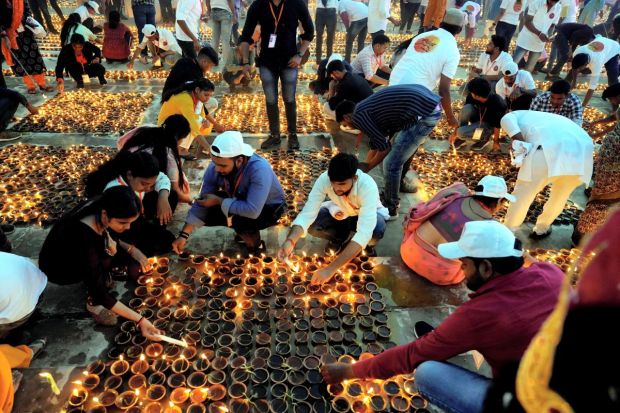 People light earthen lamps at Ram Ki Paidi during Deepotsav celebrations, on the eve of the Diwali festival, in Ayodhya