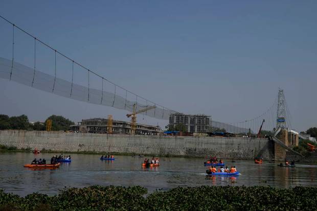 In March, the company that holds the contract for maintaining and managing the bridge, Ajanta Manufacturing Pvt. Ltd., closed it for repairs. (AP Photo)