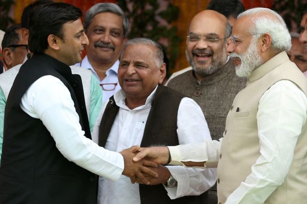 Prime Minister of India Narendra Modi along with Samajwadi Party founder Mulayam Singh Yadav and former Uttar Pradesh Chief Minister Akhilesh Yadav at BJP government swarring in ceremoney in Lucknow. (IE)