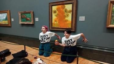 Just Stop Oil activists glue their hands to the wall after throwing soup at Vincent van Gogh's "Sunflowers" at the National Gallery in London earlier this month
