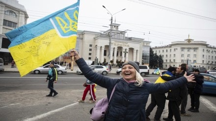 Ukrainians gather in downtown to celebrate the recapturing their city in Kherson (AP Photo)