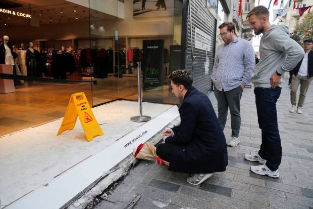 A man lays flowers to pay tribute to the victims of a Sunday's blast that took place on Istiklal Avenue, a popular spot for shoppers and tourists, in Istanbul, Turkey, November 14, 2022. (Photo source: Reuters)