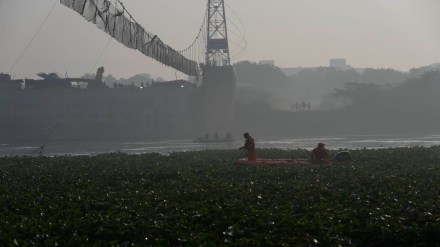 Rescuers on boats search in the Machcchu river where a pedestrian bridge collapsed on Sunday. (AP Photo/Rafiq Maqbool)
