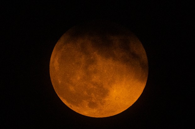 The Earth's shadow falls on the moon during a lunar eclipse in New Delhi, India, Tuesday, Nov. 8, 2022. (Photo source: AP)