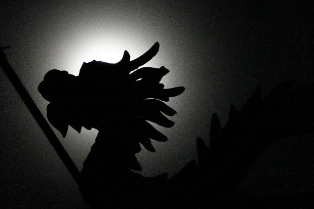 A naga statue is silhouetted against the moon during a total lunar eclipse in front of the Chinese temple in Phnom Penh, Cambodia, Tuesday, Nov. 8, 2022, (Photo source: AP)